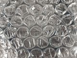 a clear glass plate on a table covered in plastic wrap