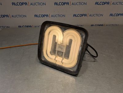 un gros plan sur une lampe posée sur une table, avec un mur en arrière-plan