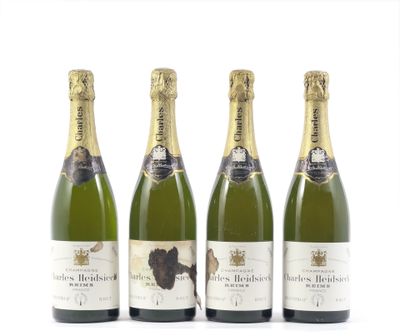 trois bouteilles de champagne posées les unes à côté des autres sur une surface blanche