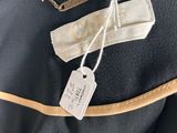 a close up of a black jacket with a tag on it