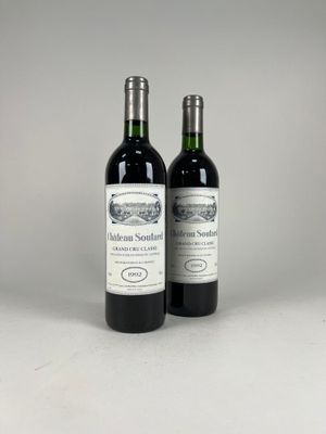two bottles of wine sitting next to each other on a table