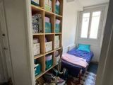a room with a bed and a book shelf in it