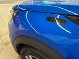 a close up of a blue car with a sticker on it