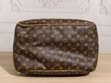 a louis vuitt toilet bag sitting on top of a wooden table