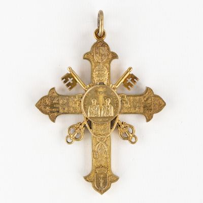 an image of a gold cross with an image of a man and a woman on it