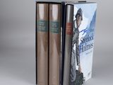 three books are stacked on top of each other on a table
