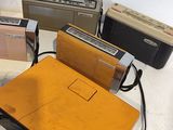 a table with a radio, a radio, and other electronics on it