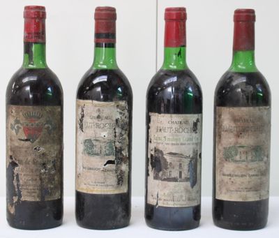 three bottles of red wine are lined up on a table
