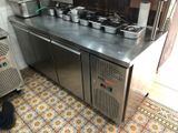 stainless steel counter top with pots and pans on it in a kitchen