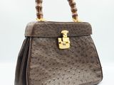 a brown ostrich ostrich leather handbag with bamboo handles