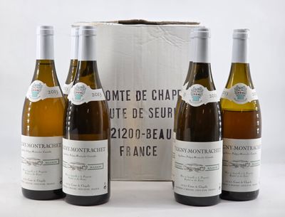 three bottles of wine are sitting in front of a box