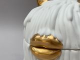 a white and gold cow shaped box with horns