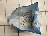 a blue bag with a pair of scissors inside of it