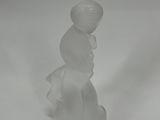a small glass figurine of a boy with a hat on