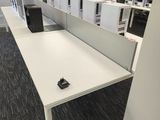 a white desk with a computer on it in a room