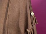 the back of a brown jacket with fringes on it