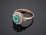 an emerald and diamond cluster ring