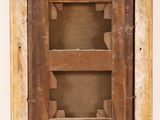 an old wooden window with a wooden frame on the wall