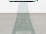 an image of a glass table with a glass top on a concrete floor