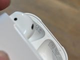 a person holding an apple airpods in their hand