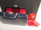 a blue suitcase and a red bag on a table