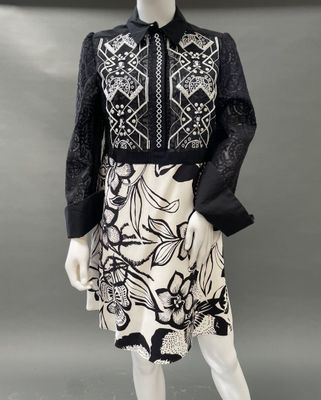 a mannequin wearing a black and white dress with a floral design