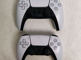 two controllers that are next to each other on a table