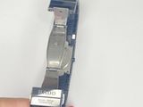 a person holding a watch in their hand on a white surface