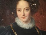 portrait of a woman in a black dress with a gold chain around her neck