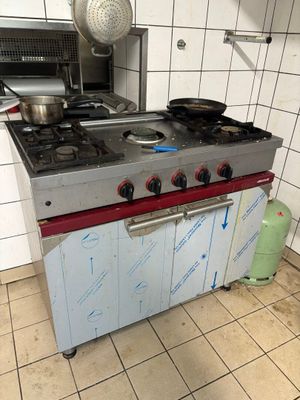 a kitchen with a stove and a pot on the counter