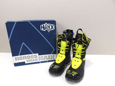 pair of black and yellow boots with yellow laces and a blue box