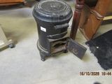 a black trash can sitting on the floor next to a chair
