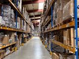 a long aisle of shelves with boxes and boxes on them