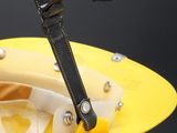 a yellow helmet with a black strap and a pair of scissors