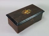 a small wooden box with a floral design on it
