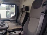a view of the inside of a truck from the driver ' s seat