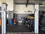 an image of a garage with a lot of tires on the floor