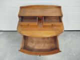a wooden desk with two drawers on top of it