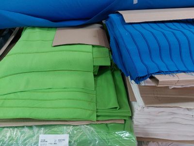 a lot of different colors of fabric on the table