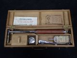 a wooden box with a set of tools inside of it