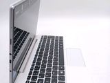 two laptops sitting side by side on a white surface