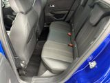 the back seats of a blue car are empty in the car