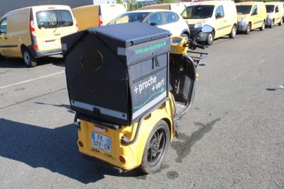 a motorcycle with a box on the back of it parked in a parking lot