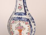 a blue and white vase with a flower design on it