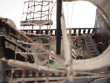 a miniature model of a pirate ship in the sand