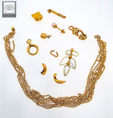 a lot of gold jewelry on a white surface