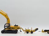 a yellow toy excavator and two other toy vehicles
