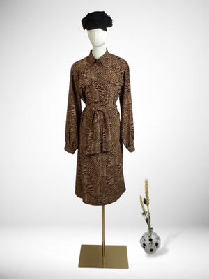 an image of a woman ' s dress and hat on a mannequin stand
