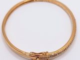 a close up of a gold bracelet with a clasp on it