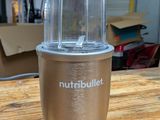 a silver blender sitting on a wooden table